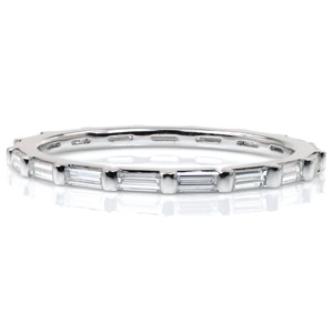 Chic, delicate diamond bands are perfect for stacking! This eternity span band features long, narrow, baguette cut diamonds. Each stone is set in a shared half-bezel setting style. This design combines modern minimalism with Art Deco elegance for a gorgeous band whether worn alone or with another piece.