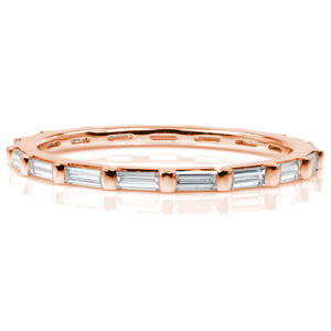 Chic, delicate diamond bands are perfect for stacking! This eternity span band features long, narrow, baguette cut diamonds. Each stone is set in a shared half-bezel setting style. This design combines modern minimalism with Art Deco elegance for a gorgeous band whether worn alone or with another piece.