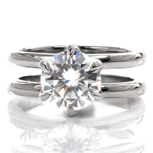 Design 3617 is a contemporary split shank design featuring an elegant, lacy, six-prong center stone setting. The two bands are matching widths and spaced to allow for a wedding band to rest between them. The luster of the high polished ring is a beautiful contrast to the sparkle of the center stone.