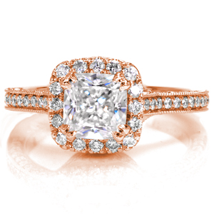 Micro pavé adorns this ring from every angle, creating a truly dazzling engagement ring design. The cathedral height cushion cut halo sits atop a geometric basket that merges to form a three-sided micro pavé band with milgrain detailing on the edges.
