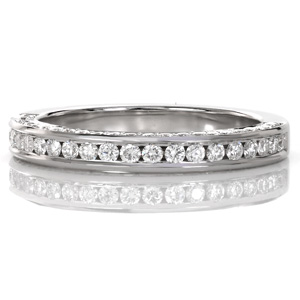 Design 3627 is a brilliant diamond band featuring stones on all three sides. The top gems are held in a channel setting style, while the sides are crafted with a bead-set style. The high polished metal of the rails and the lower band offers a shining contrast to the sparkle of the diamonds.