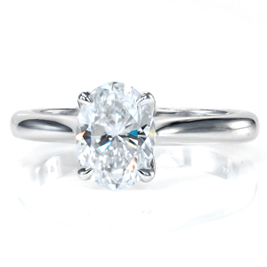Simple elegance creates the perfect solitaire engagement ring. Featuring a 1.20 carat oval diamond and a tapered band, the center stone is the showstopper of this design! The decorative basket flows into the claw prongs, and the center setting up raised to allow for easy wear with any wedding band. 