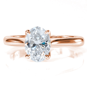 Simple elegance creates the perfect solitaire engagement ring. Featuring a 1.20 carat oval diamond and a tapered band, the center stone is the showstopper of this design! The decorative basket flows into the claw prongs, and the center setting up raised to allow for easy wear with any wedding band. 