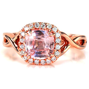 Dazzling prong set diamonds encircle a 1.70 carat cushion shape pink sapphire in Design 3652. Two high polished bands entwine to create a stunning split shank. The open pockets of the band are the perfect complement to the open gallery under the diamond halo. 
