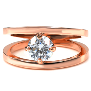 A round brilliant cut diamond makes a unique focal point to the center of this split-shank engagement ring.  The luster of the high polished ring is the perfect contrast to the sparkle of the center stone. The crisp split shank band creates a modern look for this contemporary design.