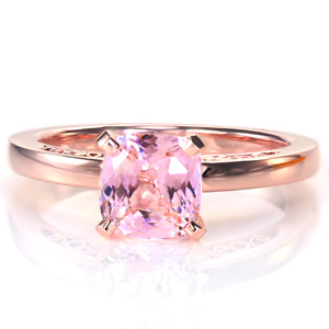 Design 3660 is a gorgeous solitaire design featuring open pockets of intricate hand wrought filigree curls. The antique inspiration is also shown with the cushion cut shape of the pink sapphire center stone. The smooth, high polished finish of the band adds focus to these lovely details. 