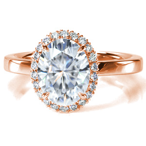 This classic diamond engagement ring design features a delicate halo made up of hand-created U-cut pavé settings. The single width, high polished band offers a contrast to the sparkle of the halo and center stone. This beautiful ring was designed to allow easy pairing with a variety of wedding band styles.
