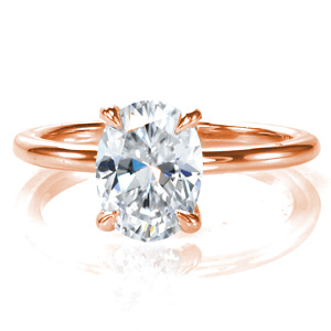 Simple elegance perfectly describes our Oval Petite design. This single-width band is shown with a flowing four prong center setting. The setting is designed to allow for easy wear of a variety of wedding band styles. Currently shown with a 1.00 carat oval, this beautiful ring will be a timeless classic.