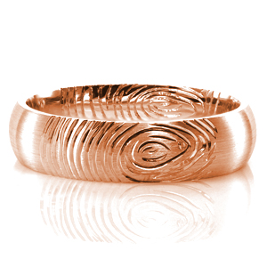 Adding the fingerprint of your future spouse to the design of your wedding band is a beautiful way to keep a piece of them with you wherever you go. This custom domed band is shown with a comfort fit interior. The brushed finish on the outside of the band offers contrast to the lines of the print.