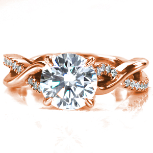 Design 3673 is a uniquely twisting split shank design featuring one band set with diamonds and one band high polished. Around the sides of the center setting small diamonds have been set for added sparkle! This design is shown here with a 1.50 carat round brilliant cut center stone. 