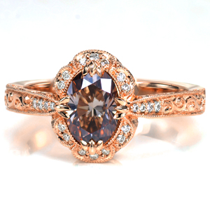 Design 3677 is a stunning custom diamond engagement ring featuring hand wrought details with vintage styling. The relief style scroll engraving on the band is complimented by the delicate filigree curls in the basket under the halo. The scalloped halo sits atop a tapered band with all the edges textured with miglrain.