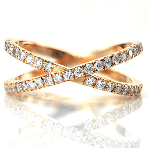 Two 14k yellow gold bands are joined to create texture and dimension. Both bands are adorned with a French, hand cut style of pave called U-cuts, maximizing the fire and brilliance of the diamonds. The bands are joined at the bottom for a comfortable fit. 