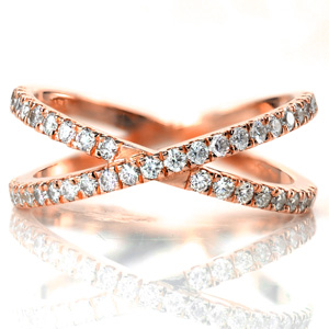 Two 14k yellow gold bands are joined to create texture and dimension. Both bands are adorned with a French, hand cut style of pave called U-cuts, maximizing the fire and brilliance of the diamonds. The bands are joined at the bottom for a comfortable fit. 