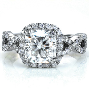Shown with a 2.0 carat cushion cut center stone, Design 3692 features a unique micro pavétwisted split shank design. Hand formed u-cuts minimize the metal holding the stones while securely fashioning the stones, giving this ring maximum sparkle. A diamond halo around the center stone completes this stunning ring.