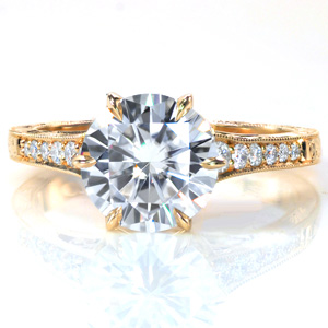 A stunning 1.70 carat center stone is set in a classic 6-prong cathedral setting. The antique inspired band is accented with bright cut hand engraving, milgrain edges, and pockets of hand wrought filigree curls. Surprise diamonds in petal shapes are visible from the sides, while six diamonds adorn the top of the band.