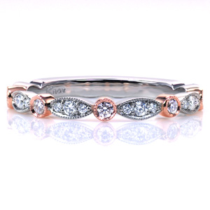 Our Slipper Two Tone band combines texture and color in a beautiful custom update. Warm rose gold is incorporated in an alternating pattern with white gold, and the variety of stone settings adds a unique touch. Hand applied milgrain edging is added for a vintage inspired touch.