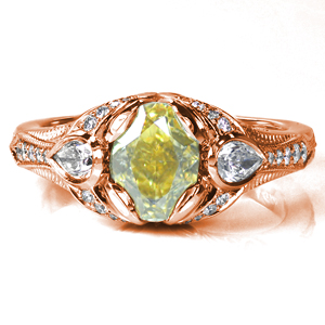 Design 3705 has a customized setting surrounding a vibrant yellow center diamond with two pear cuts on each side. As the flared band tapers down, fine details of milgrain and round diamonds graduating in size adorn the band. Hand formed filigree curls are tucked under two grand swirls creating a great profile look.