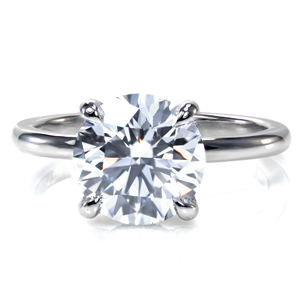 A dazzling 2.50 carat center stone is simply showcased in an elegant four prong setting. A decorative basket adds a bit of extra sparkle and flair and gives the profile view added interest. Set in gleaming platinum, this classic solitaire is a timeless statement of elegance and grace. 