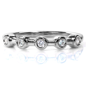 Design 3722 is a clean, modern band that works equally well as a wedding band, a right hand ring, or a stacking band. Five round brilliant cut diamonds sparkle in bezel settings along the simple, high polish band. Simple and elegant, this design can be customized to any size stone. 