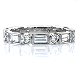 Design 3727 is striking on its own or stacked with other bands. It features alternating bezel set round brilliant diamonds and baguettes of more than 1 carat total weight in an eternity band. Contemporary and geometric, this design is sure to get noticed!