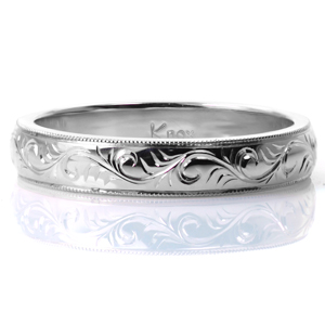 Intricate hand engraving in a delicate scroll pattern adorns this elegant 4mm band. Milgrain detail is hand applied to the bright cut edges, and the all sides of the band are brought to a high polish sheen. This band can be customized easily with a different engraving pattern or a different width. 