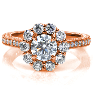 Design 3733 features a striking, large halo. The band is accented with diamonds and a double row of milgrain detail. The profile reveals an intricate, decorative basket also adorned with milgrain, as well as beautifully hand engraved patterns on the sides of the band. 