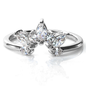 Design 3736 features a combination of dazzling round brilliant and marquise cut diamonds, custom contoured to fit around an engagement ring. This ring can be easily customized around any shape center stone. A stunning way to add dimension and sparkle to your wedding set, this design definitely makes a statement!