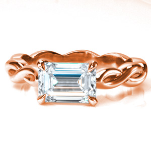 Design 3740 features a stunning east-west set 1.0 carat emerald cut diamond in a simple, 4 claw prong setting. The unique, high polished band twists in a repeating infinity sign pattern that spans the entire ring. A modern take on the solitaire, this ring is a new classic!