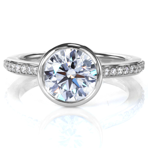 A 1.0 carat diamond is showcased in a full bezel setting in Design 3741. An open gallery under the center setting provides a beautiful, clear view of the stone. A cathedral style band is adorned with beadset diamonds, and the ring is brought to a mirror like high polish finish, completing this modern ring. 