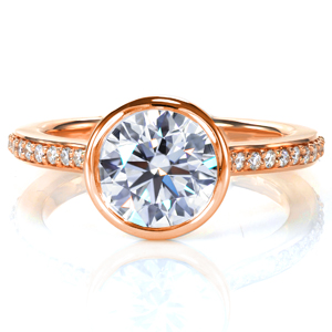 A 1.0 carat diamond is showcased in a full bezel setting in Design 3741. An open gallery under the center setting provides a beautiful, clear view of the stone. A cathedral style band is adorned with beadset diamonds, and the ring is brought to a mirror like high polish finish, completing this modern ring. 