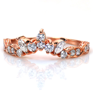 Design 3746 contours perfectly to frame your engagement ring in even more sparkle! A combination of marquise shaped and round brilliant diamonds create a beautiful pattern, and the band features more round diamonds set in a scalloped design. Milgrain detail and relief engraving are added for a touch of vintage flair. 