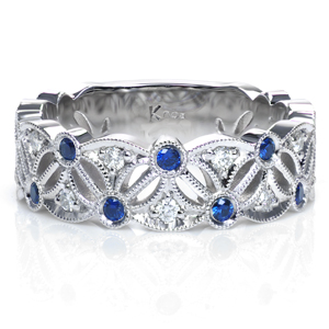 Design 3750 has an elegant, vintage inspired, pierced pattern. Scalloped edges and decorative marquise shaped openwork create an eye catching design. Bezel set sapphires alternate with beadset diamonds to add color and sparkle. The edges are framed with milgrain detail for an added antique feel.