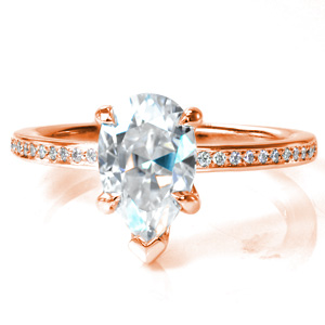 The 0.70 carat pear shaped diamond sits in a classic, gently curving setting in Design 3760.  The high polished band features sparkling micro pavé diamonds which perfectly complement the center stone. Worn alone or paired with any number of wedding bands, this ring will be stunning!
  