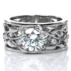 A dazzling 1.20 carat diamond is nestled in unique, petal shaped prongs. The intertwining leaf and vine design of the band is accented with round brilliant diamonds, sparkling between the vines. This wide band is finished with thin rails on each side of the ring and a high polish shine. 