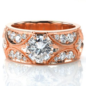 Design 3764 features a 1.0 carat round center stone set within a delicate eight prong setting. The design is accentuated with micro pavé diamonds that are bead set by hand within antique inspired crescent shapes. The design is framed with milgrain detail, adding to the vintage inspired appeal. 