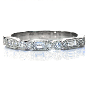 Isabella is a striking, art deco inspired creation perfect worn alone, alongside an engagement ring, or as part of a stack. Baguettes and round brilliant diamonds provide sparkle and hand-applied milgrain detail adds vintage flair and texture. This design is completed with high polished sides. 