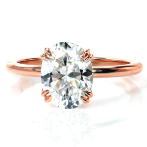 Our Chiffon solitaire is all about the little details. A delicate, draped basket adorns a sparkling 1.70 carat oval diamond. Elegantly curved, tiny double claw prongs hold the diamond securely in place. This gorgeous yet simple design is finished with a thin, rounded band. 