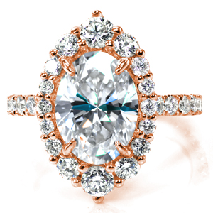 A true statement piece, Design 3796 showcases a 2.5 carat oval diamond in an impressive, marquise shaped halo comprised of different sizes of round diamonds. The thin band features more hand set diamonds for added sparkle from every angle. Prepare to be dazzled!