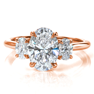 Design 3801 is a classic three stone engagement ring with a modern update. A 1.7 carat oval diamond is flanked by oval diamonds on each side, creating a beautifully symmetric look. The basket setting is decorated with sparkling diamonds, and the high polish of the band complements the brilliant diamonds beautifully. 