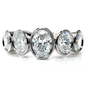 A modern update on the classic five stone band, this design showcases five oval diamonds graduating in size toward the center. The diamonds, totaling two carats, are securely set in low, polished bezels for a clean, streamlined look. This design is perfectly proportioned to cover your finger in sparkle!