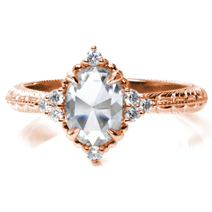 If you're looking for a ring with vintage flair, this is it! A stunning rose cut oval sits just atop the finger, flanked by clusters of small round diamonds on each side. Enchanting beads of metal and more diamonds surround the center stone. The thin band features intricate hand engraving and milgrain detail. 