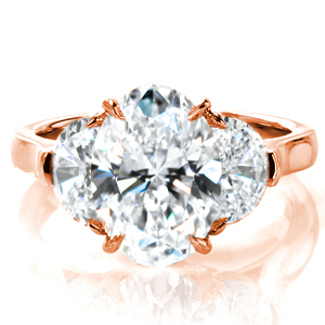 Why choose between an engagement ring and a statement piece when you can have both? A stunning 3.5 carat oval cut diamond is flanked by large half moon diamonds in a classic cathedral setting. Delicately draped baskets and claw prongs hold the diamonds securely in place, and a high polished band completes the design. 