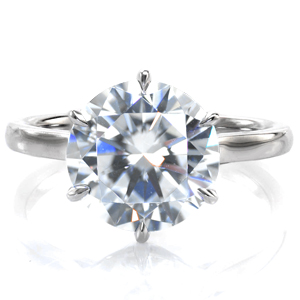 A stunning 3 carat round brilliant diamond is held in an elegant six prong setting in this lovely solitaire setting. A delicate, scallop shaped basket adds intriguing detail to the profile of this cathedral setting. A high polish band is the perfect complement to the captivating center stone. 