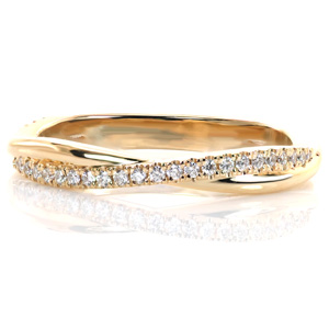 Dainty and delicate, this band works perfectly alongside a variety of engagement ring styles or as part of a stack. Intertwining bands of high polished metal and glimmering hand-set diamonds provide beautiful texture and balance in this gently curved design. 