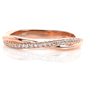 Dainty and delicate, this band works perfectly alongside a variety of engagement ring styles or as part of a stack. Intertwining bands of high polished metal and glimmering hand-set diamonds provide beautiful texture and balance in this gently curved design. 