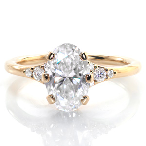 Based on a vintage ring, Design 3788 features a 1.5 carat diamond held in a unique six prong setting. The high polished band flares into the center setting and holds clusters of five diamonds on each side of the elevated center setting, drawing the eye to the dazzling center stone.