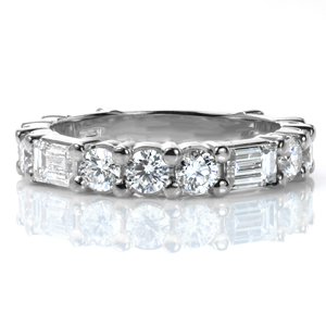 A true statement band for a wedding, an anniversary, or a stacking ring set, this design is sure to catch your eye! A baguette diamond is alternated with three round diamonds to create a geometrical pattern. The mix of brilliant cut round diamonds and step-cut baguettes creates a dazzling sparkle.