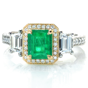 A stunning vintage-inspired design, this ring truly showcases the artistic ability of our master jewelers. A vibrant emerald is surrounded by a diamond halo in yellow gold and flanked with trapezoid diamonds. The platinum band is adorned with stunning, hand-done engraving, bead-set diamonds, and milgrain detail.