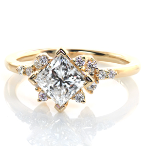 This lovely engagement ring features a kite set princess cut diamond nestled in between clusters of shimmering rounds. More prong set diamonds protrude from the basket setting, adding another layer of sparkle. A narrow band with a mirror-like finish completes this design. 
