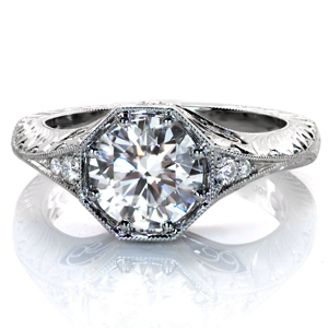 This eye-catching design showcases a 1.5 carat round brilliant cut center diamond in a unique octagonal setting. Side stones taper into a an elegant band adorned with two styles of hand-done engraving. Beautiful hand formed filigree curls, milgrain detail, and clusters of surprise diamonds complete this lovely ring.